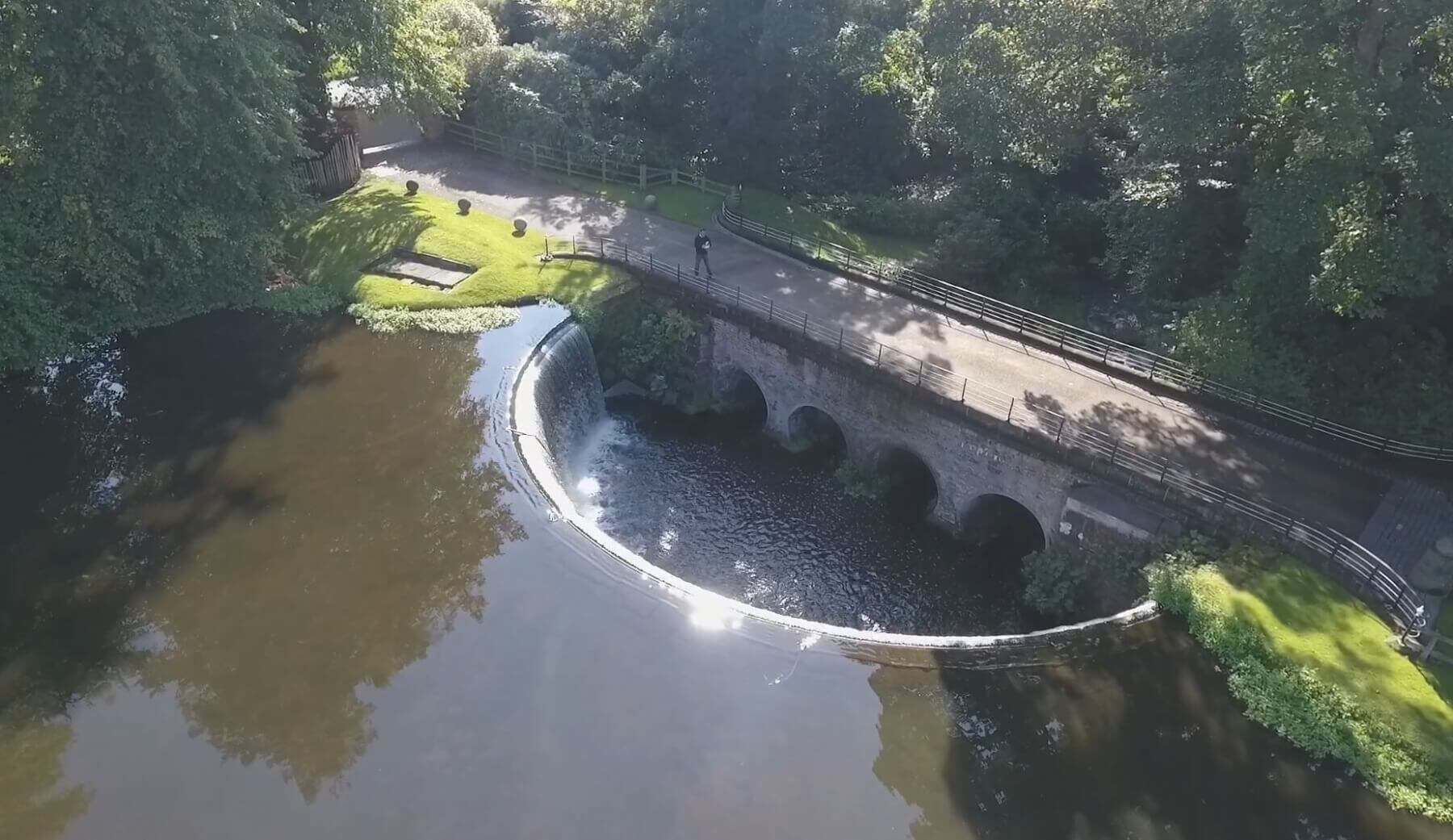 16th Century bridge repointing – aerial view showing curved bridge over river