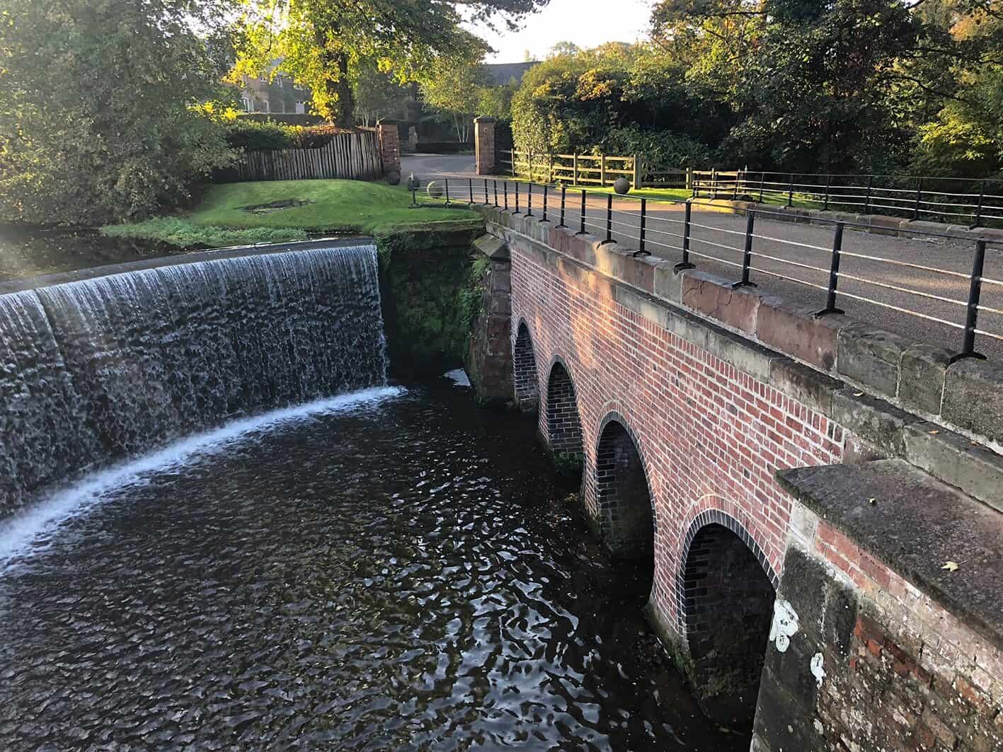 Historic bridge over waterfall and weir after lime mortar repointing