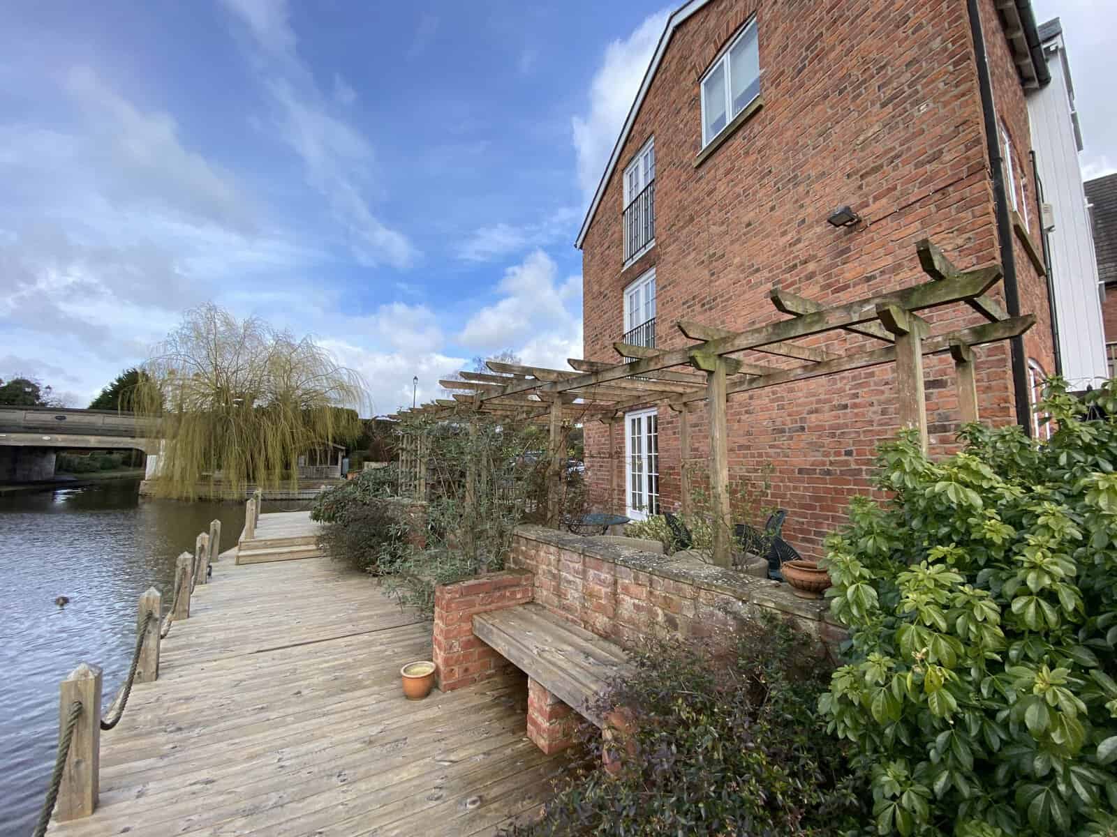 Cheshire Pointing Ltd property with riverside walkway and garden features.