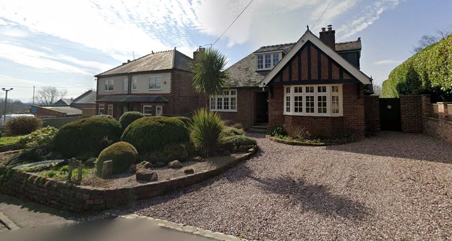 Historic brick building undergoing restoration with scaffolding in Cheshire.
