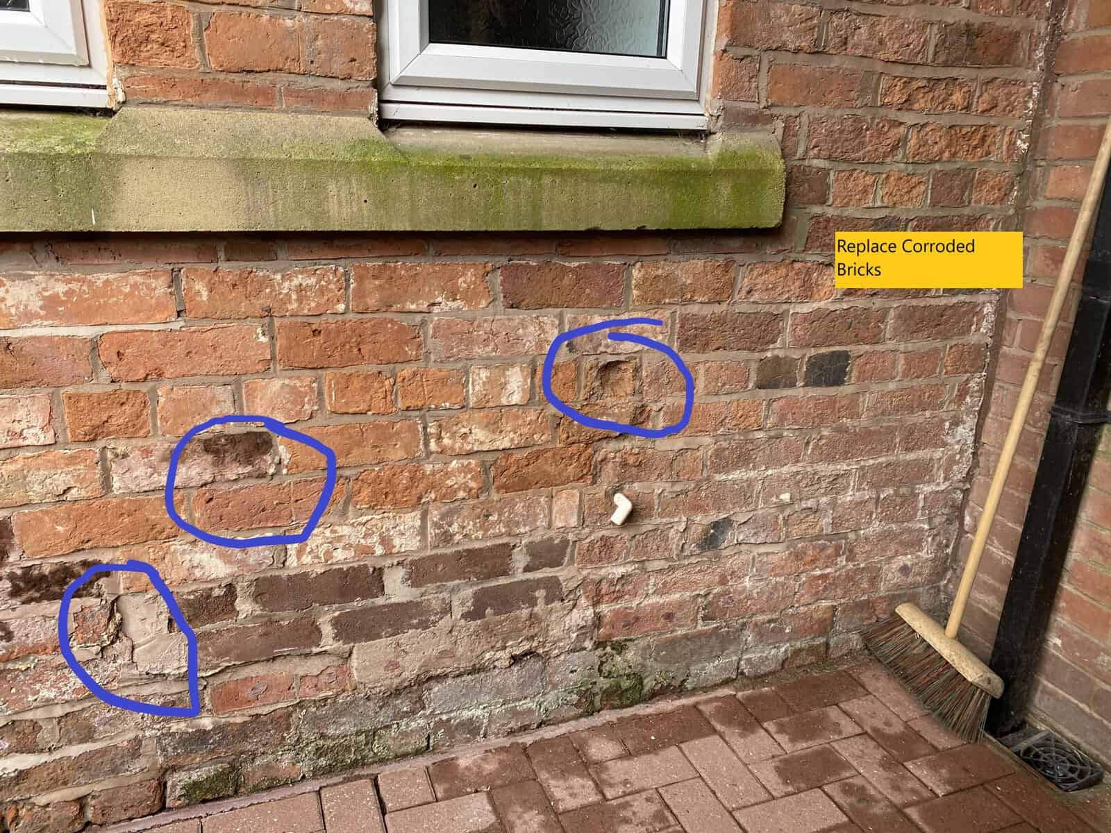 Brick wall with three areas marked for brick replacement in Waverton.