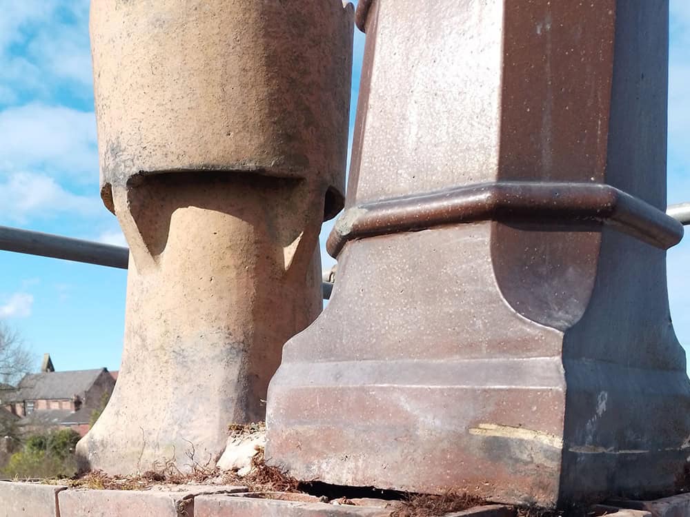 Close-up of stone pedestal and base with weathered surface and detailed craftsmanship.